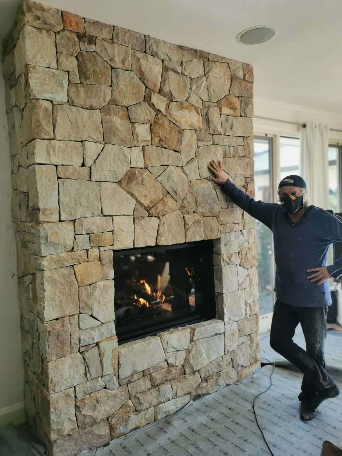 Indoor dry stacked stone fireplace wall