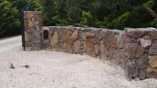 Stone entrance wall, gate pillar and letterbox